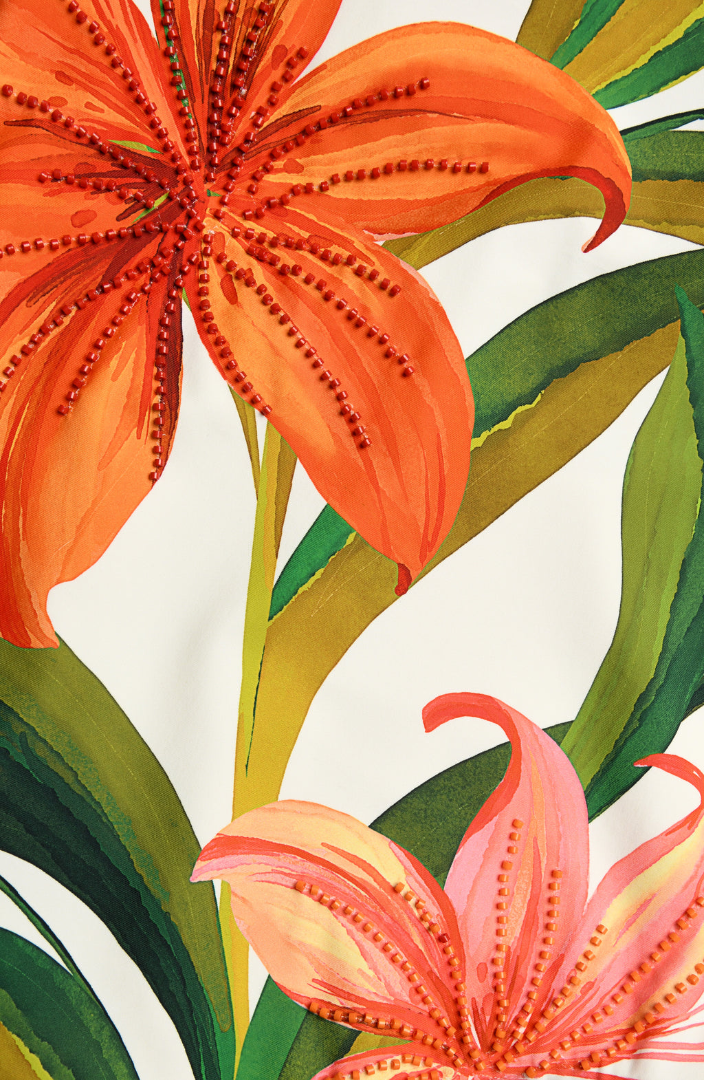 Close-up image of a floral one piece swimsuit with beading detail