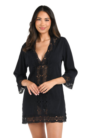 Model is wearing a black v-neck tunic swimsuit cover up from our Island Fare collection.