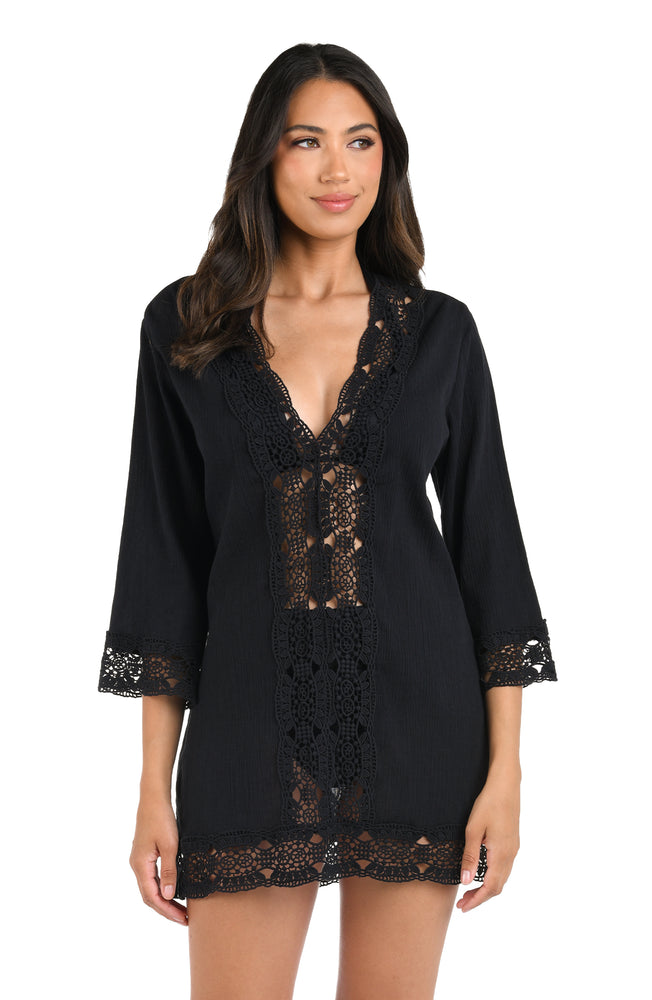 Model is wearing a black v-neck tunic swimsuit cover up from our Island Fare collection.