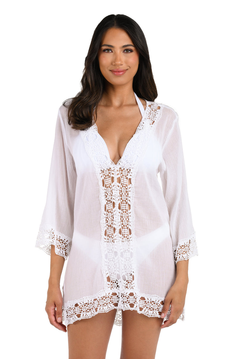 Model is wearing a white v-neck tunic swimsuit cover up from our Island Fare collection.