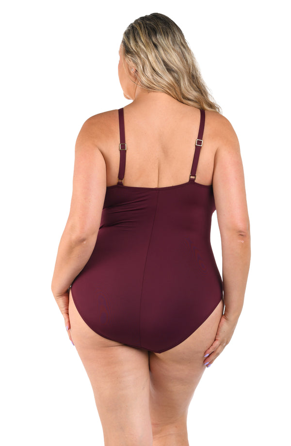 Back image of plus size model wearing a solid dark cherry colored one-piece swimsuit featuring thin over the shoulder adjustable straps, straight back, and moderate rear coverage.