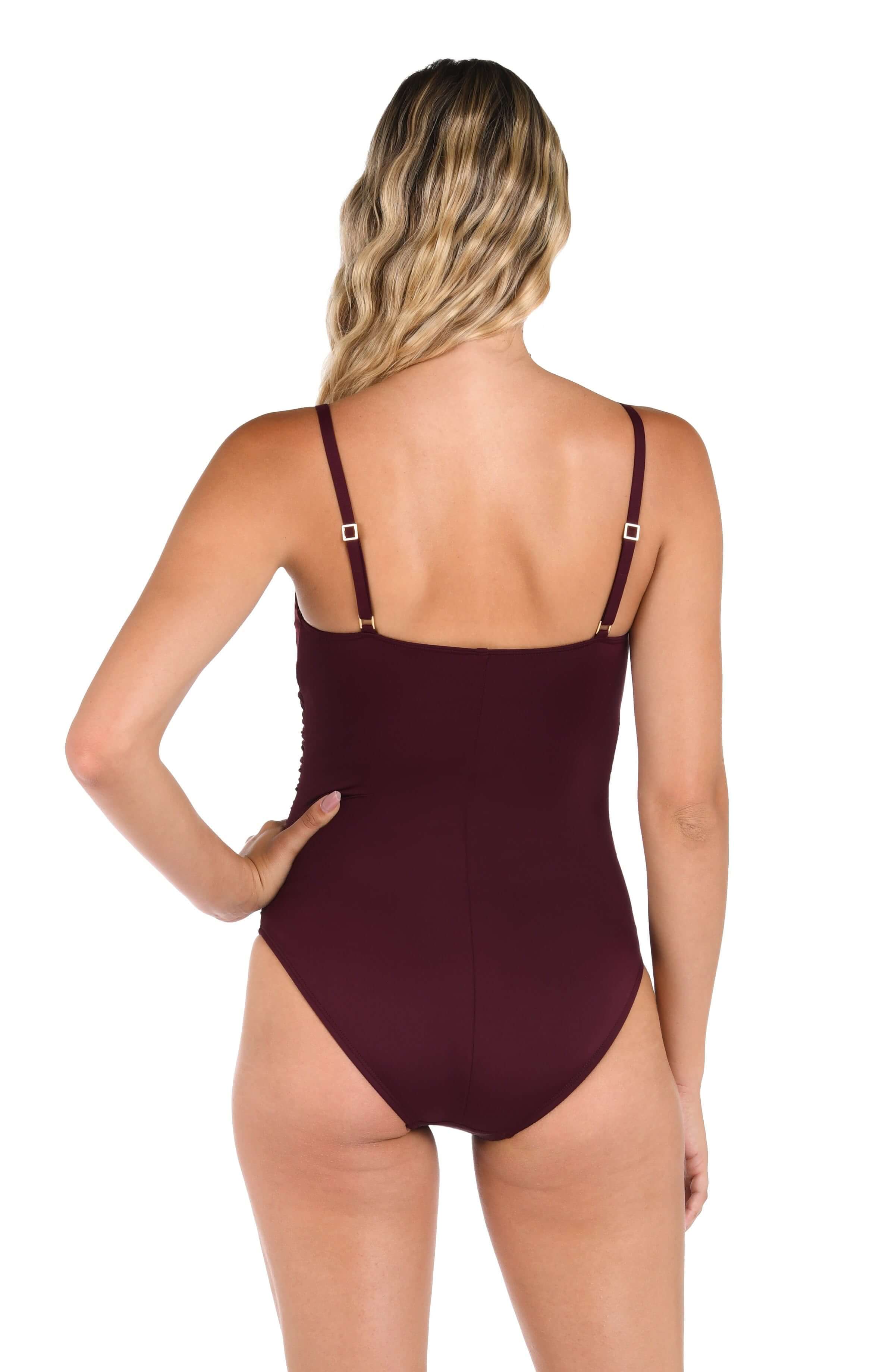 Back image of model wearing a solid dark cherry colored one-piece swimsuit featuring thin over the shoulder adjustable straps, straight back, and moderate rear coverage.