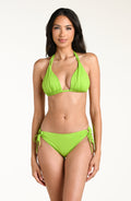 Woman wearing an apple green bikini top and matching bottom against a white background. 