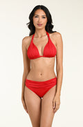 Woman wearing a red bikini top and matching bottom against a white background. 