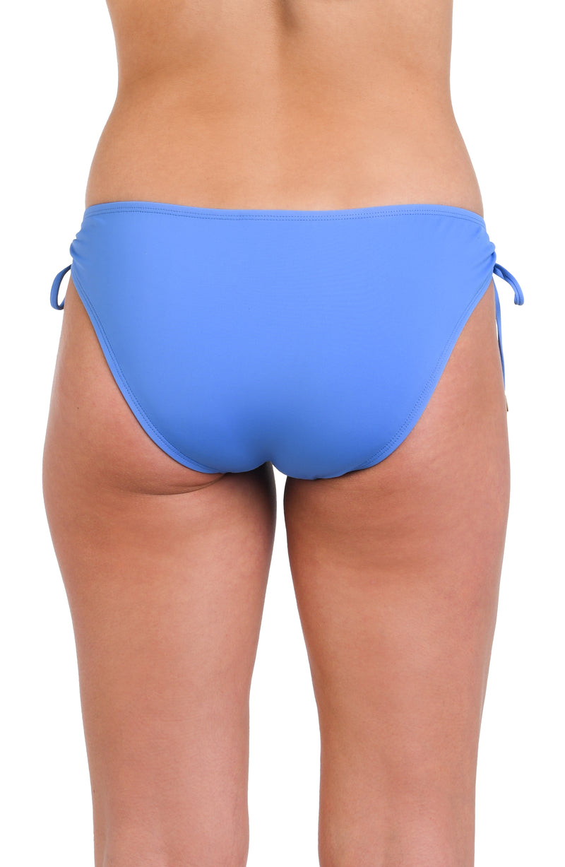 Model is wearing a solid chambray (light blue) colored side-tie hipster swimsuit bottom.