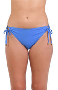Model is wearing a solid chambray (light blue) colored side-tie hipster swimsuit bottom.