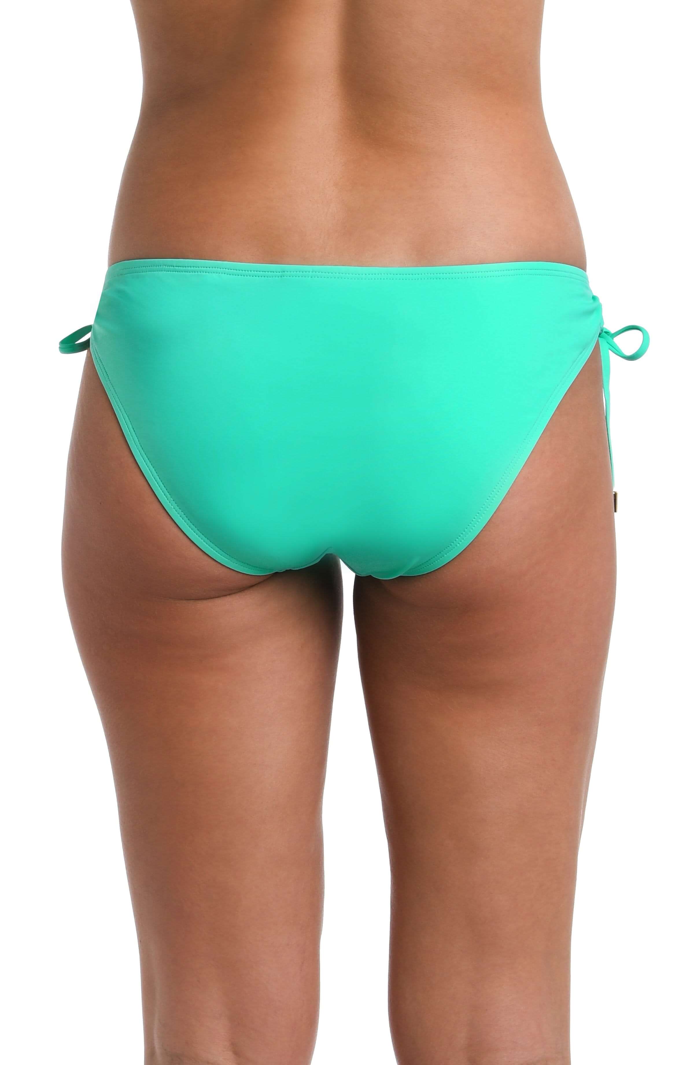 Back image of model wearing a solid seafoam colored Side Tie Hipster Bottom. 