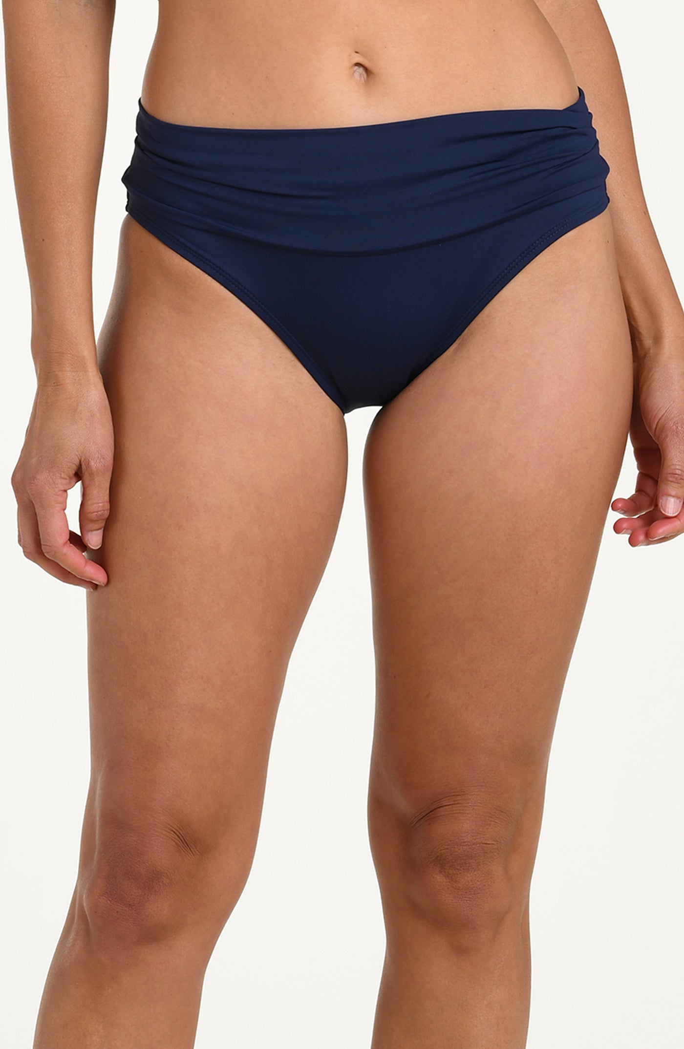 Front image of model wearing an indigo (navy blue) colored bikini bottoms with a wide, ruched waistband.