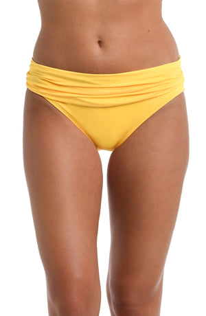 Model is wearing a solid pineapple colored Shirred Band Hipster Bottom