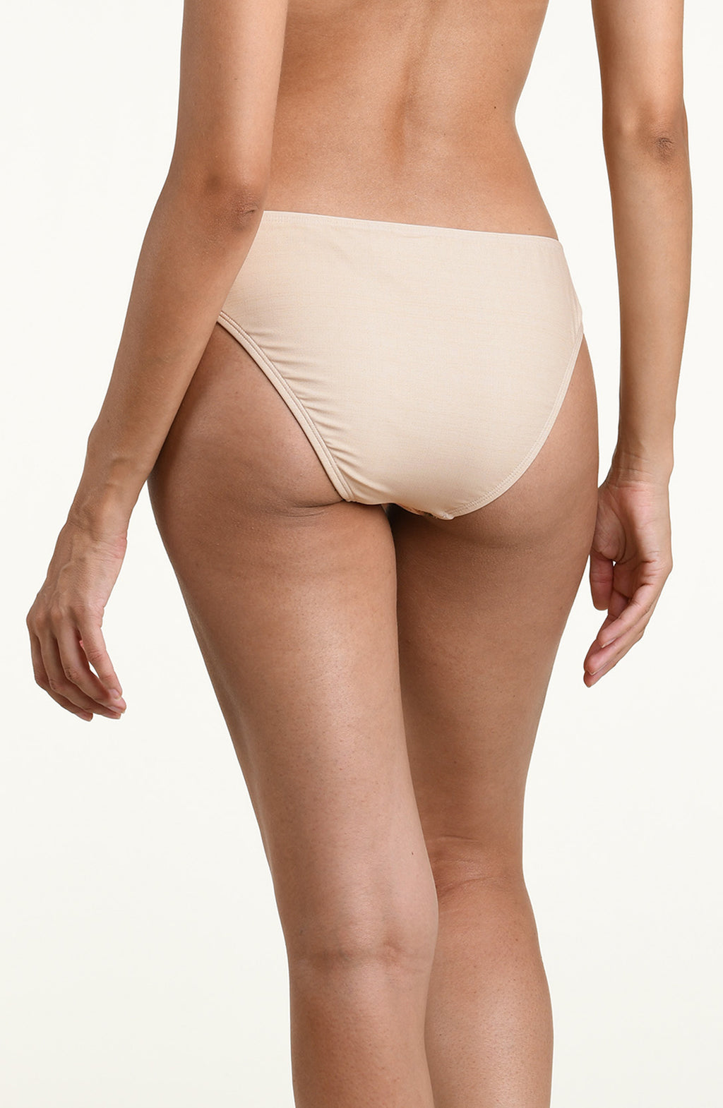 Woman wearing a multicolored white bikini bottom against a white background. 