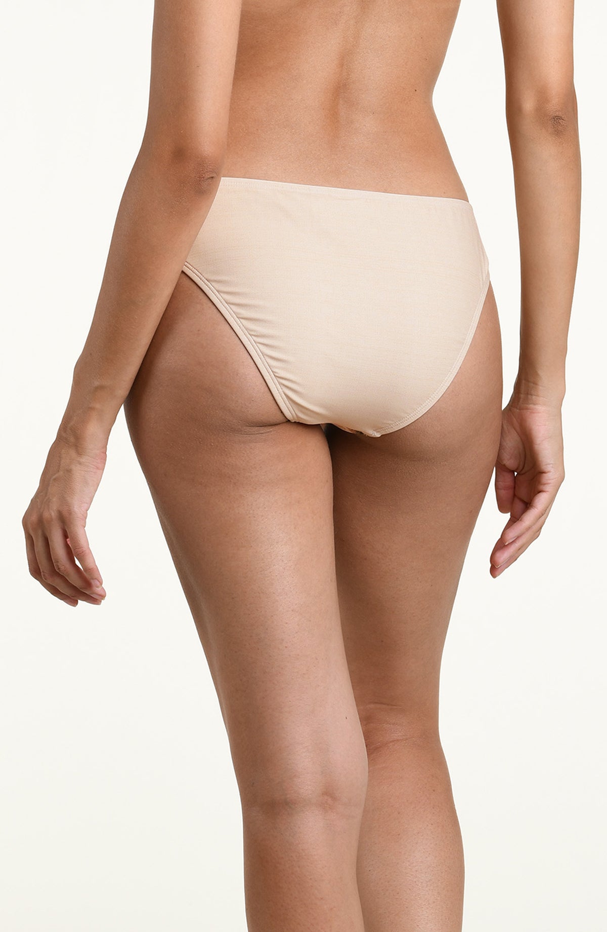 Woman wearing a multicolored white bikini bottom against a white background. 
