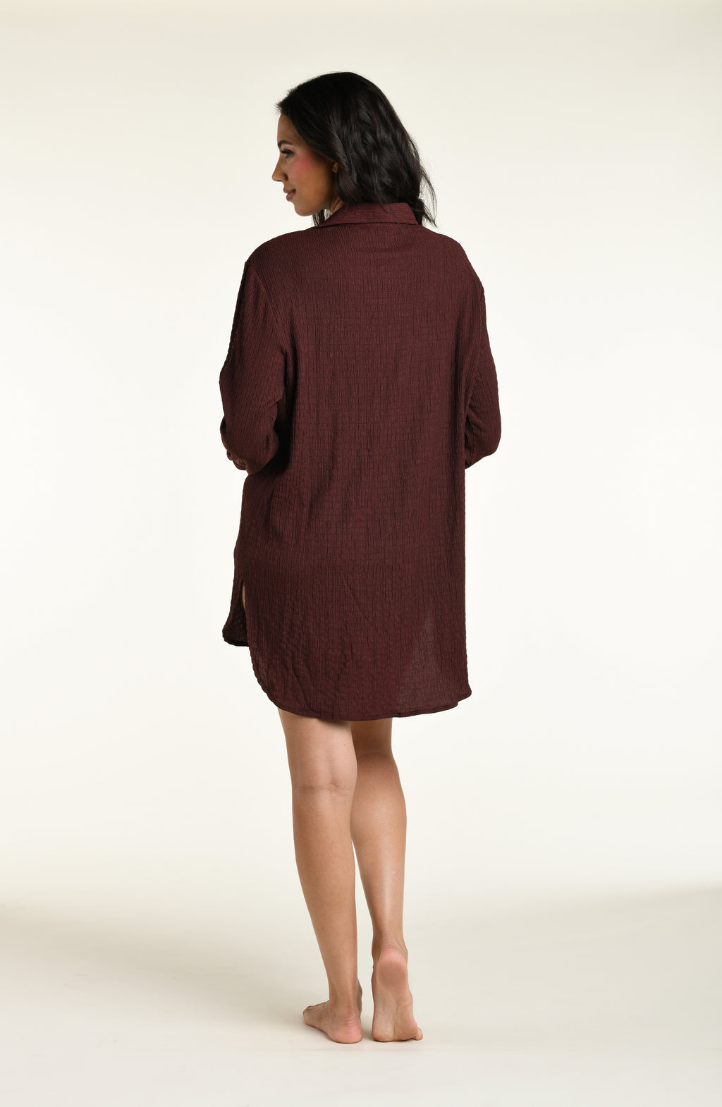 Woman wearing a java brown colored long sleeve cover up top against a white background. 
