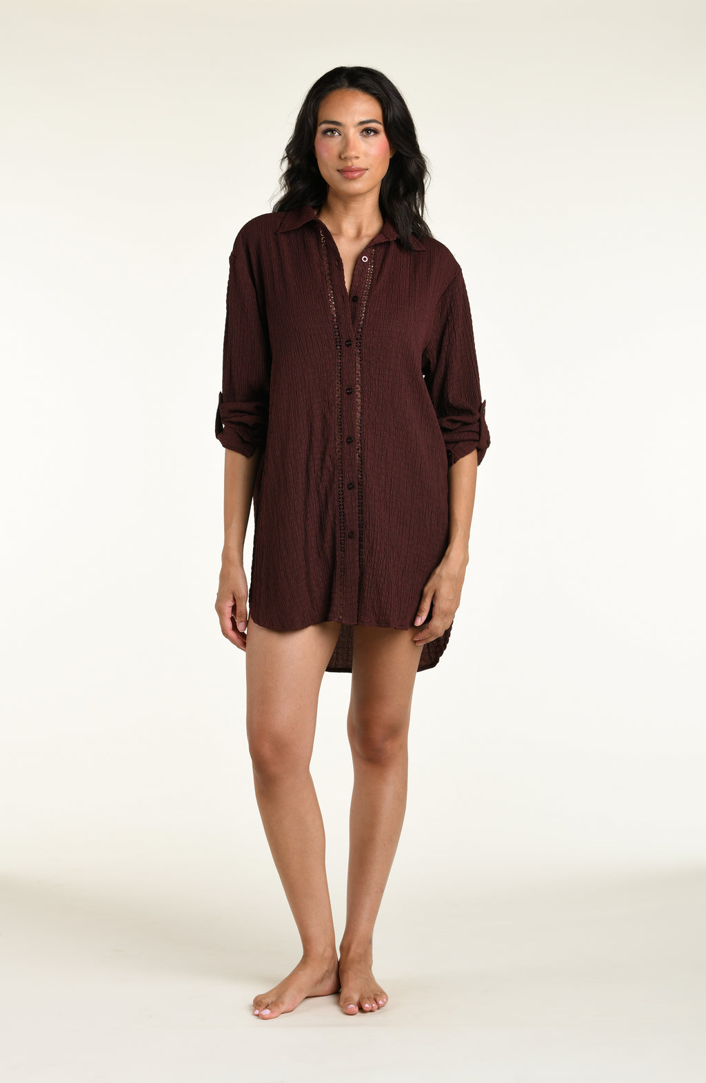 Woman wearing a java brown colored long sleeve cover up top against a white background. 
