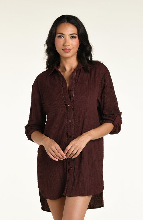 Woman wearing a java brown colored long sleeve cover up top against a white background. 
