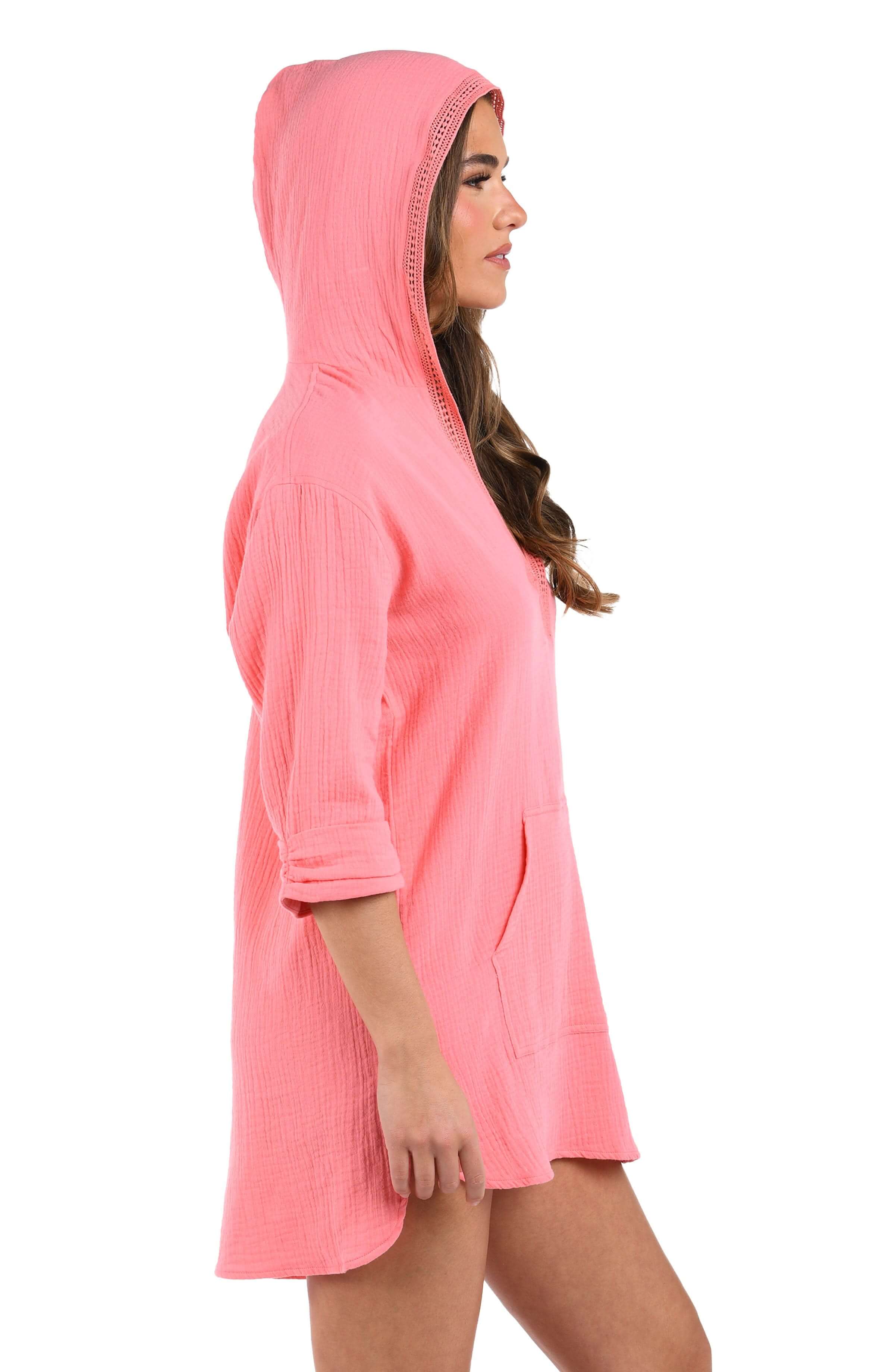 Side image of model wearing the Seaside Covers Hoodie in Light Coral