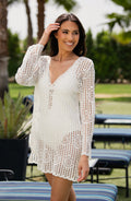Lifestyle image of a model wearing a solid ivory crochet v-neck dress cover up from our Waverly Covers collection.