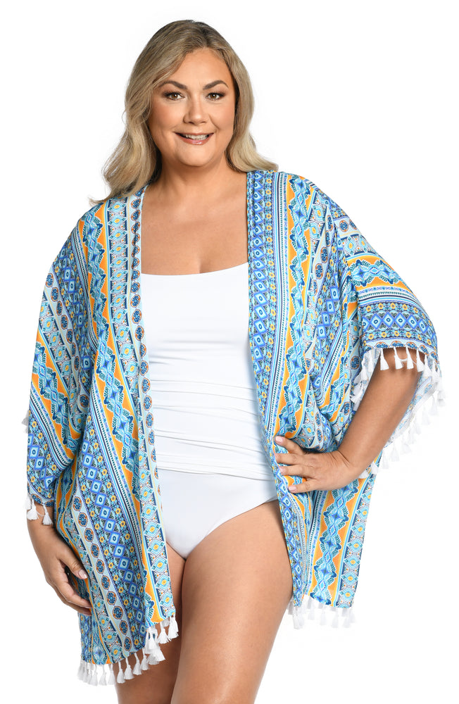 Model is wearing a blue multicolored mediterranean printed open front kimono cover up from our Scarf City collection.