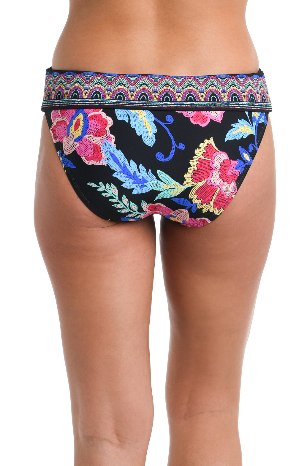 Back image of model wearing a black, pink, and blue multicolored floral patterned hipster bikini swimsuit bottom featuring a band and moderate rear coverage. 