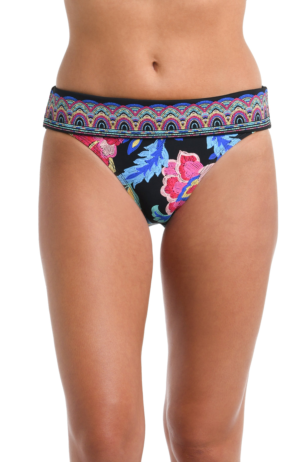 Front image of model wearing a black, pink, and blue multicolored floral patterned hipster bikini swimsuit bottom featuring a front band.