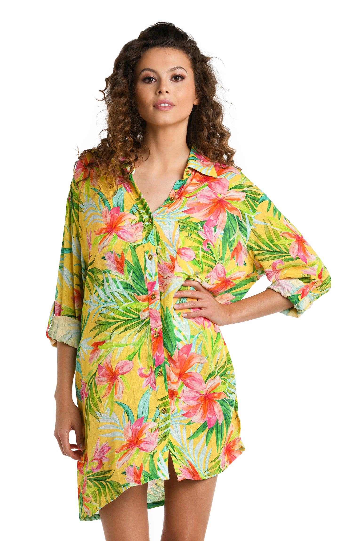 Model is wearing a bright yellow, pink, and green multicolored tropical printed Button Up Camp Shirt