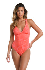 Model is wearing a coral colored palm printed Macrame Back One Piece