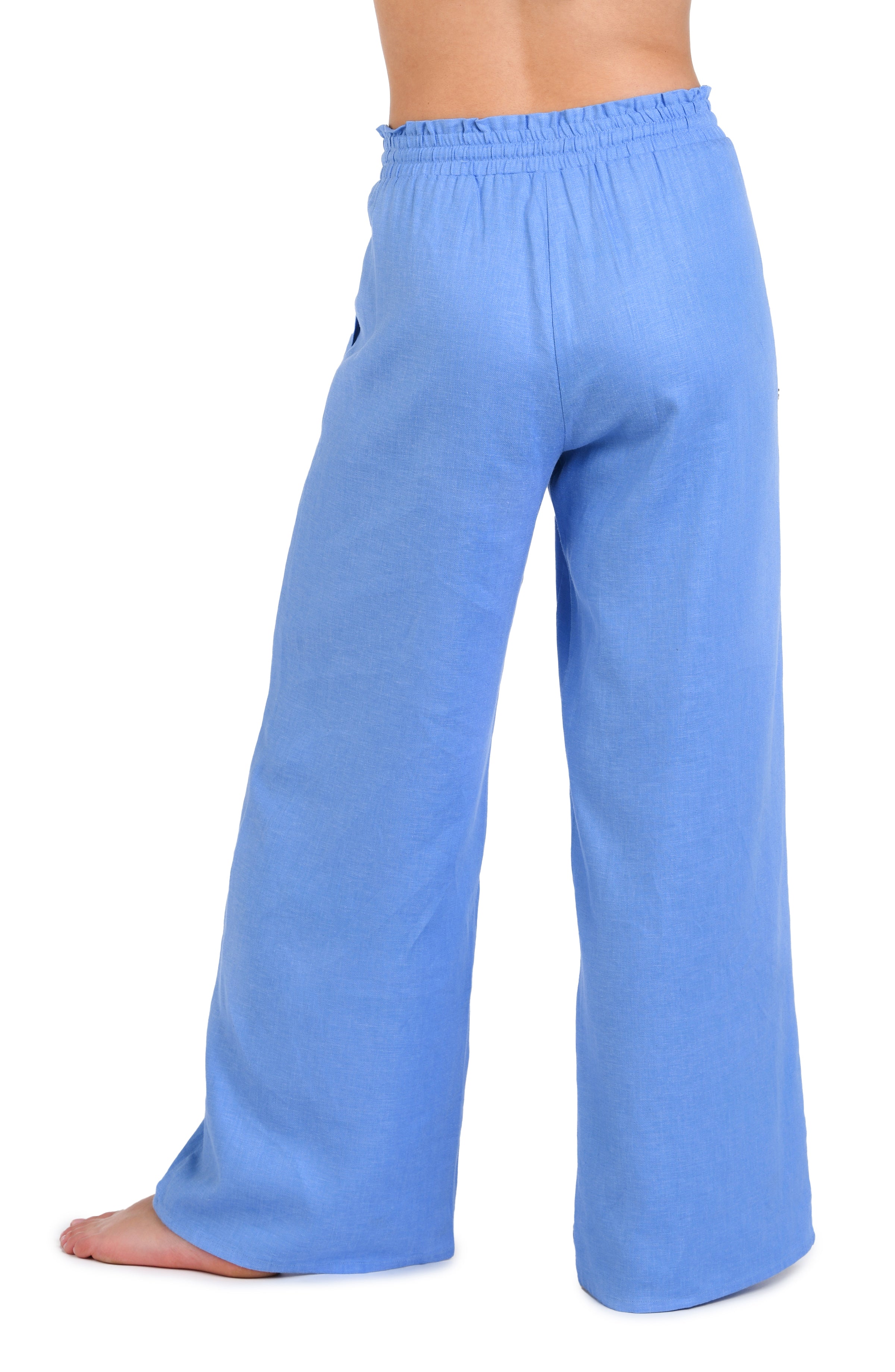 Model is wearing a solid chambray (light blue) colored beach pant cover up.