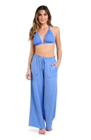 Model is wearing a solid chambray (light blue) colored beach pant cover up.