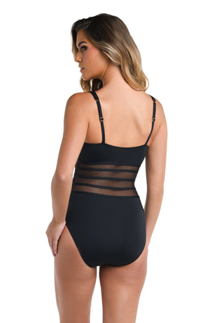 Model is wearing a multicolored Island Goddess Mesh Over The Shoulder One Piece Swimsuit