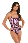 Front image of model wearing a one piece swimsuit with thin over the shoulder straps in a bold pink and maroon floral print. 
