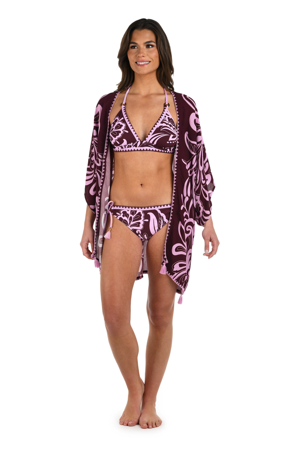 Full body front image of model wearing a dark cherry and pink tropical patterned open front kimono cover up. 