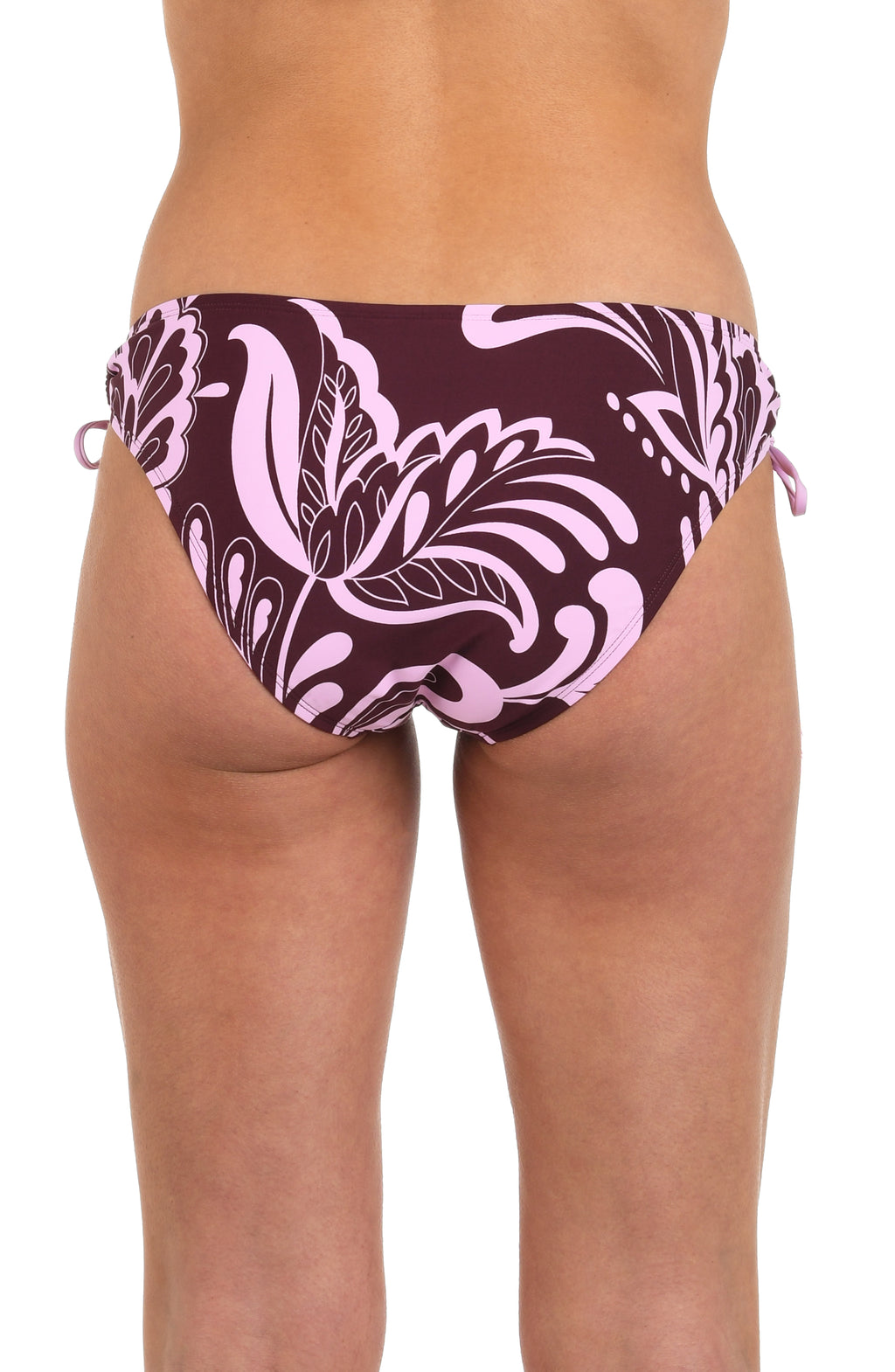 Back image of model wearing hipster bikini bottoms with side ties and tassels, in a bold pink and maroon floral print. 