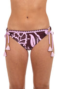 Front image of model wearing hipster bikini bottoms with side ties and tassels, in a bold pink and maroon floral print. 