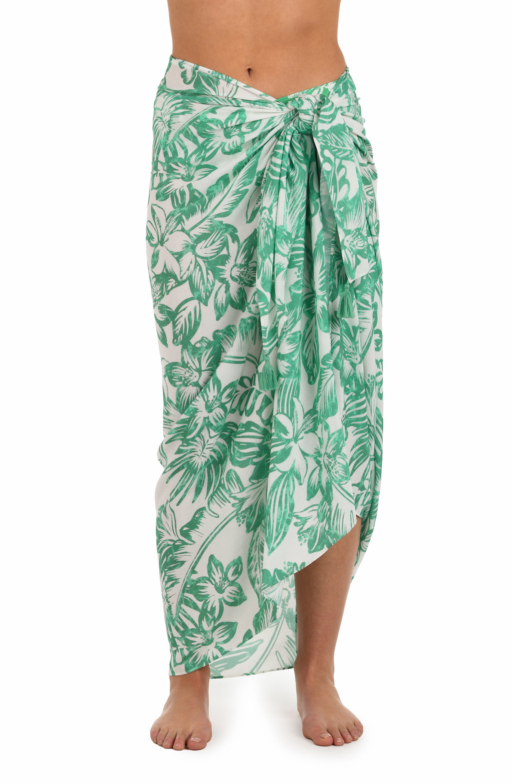 Front image of model wearing a green and white tropical-print pareo wrap cover up. 