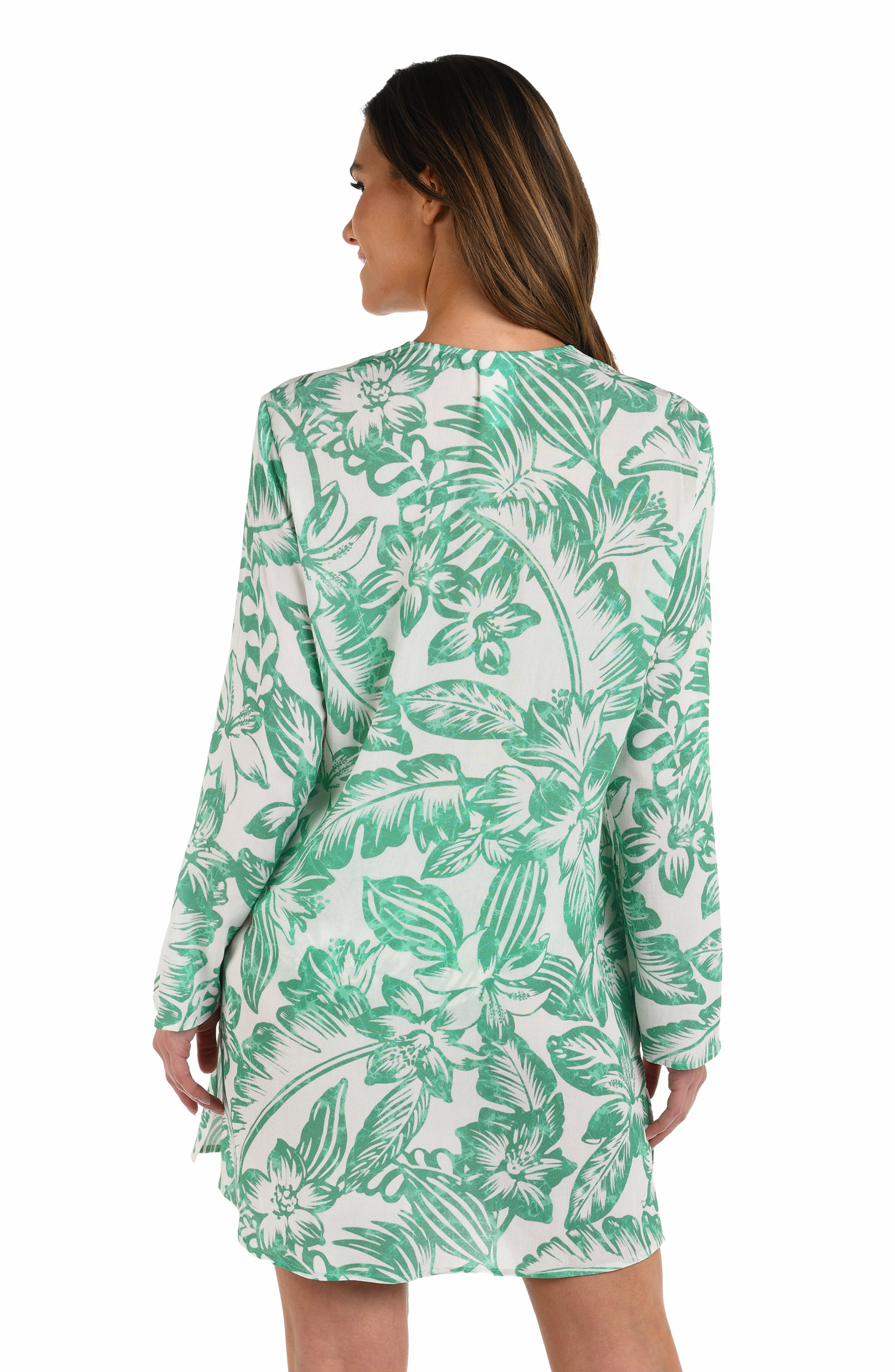 Back image of model wearing a green and white floral-printed long-sleeve tunic with a lace-up neckline and side pockets.