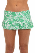Front image of model wearing a green and white floral-printed ruffle skirted bottom featuring a built-in brief and a shirred body. 