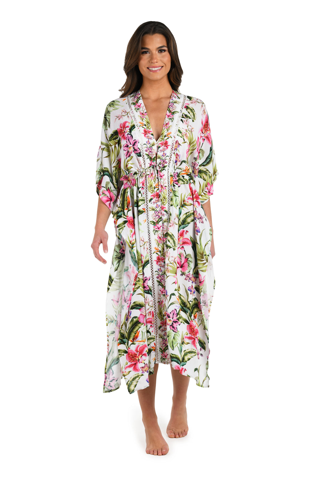 Full body front image of model wearing a long floral kimono cover-up featuring a deep V-neckline, flowy three-quarter sleeves, and a vibrant tropical print on lightweight fabric.