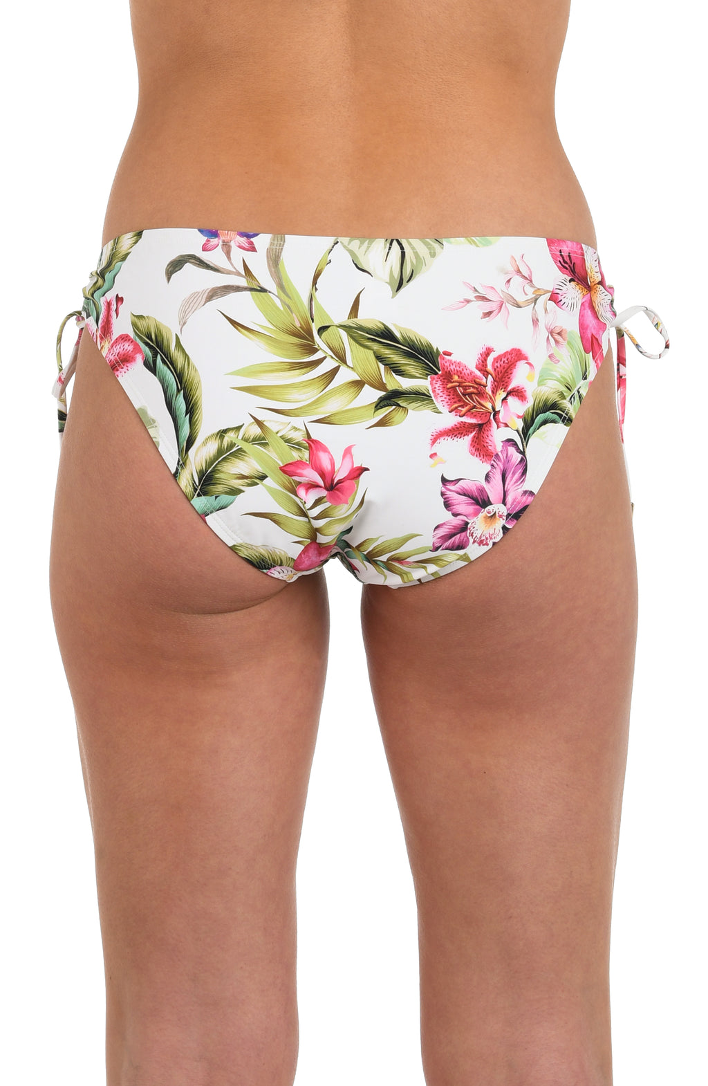 Back image of model wearing a white, pink, and green multicolored floral printed hipster bikini bottom featuring adjustable loop side ties with gold cord ends, and moderate rear coverage.
