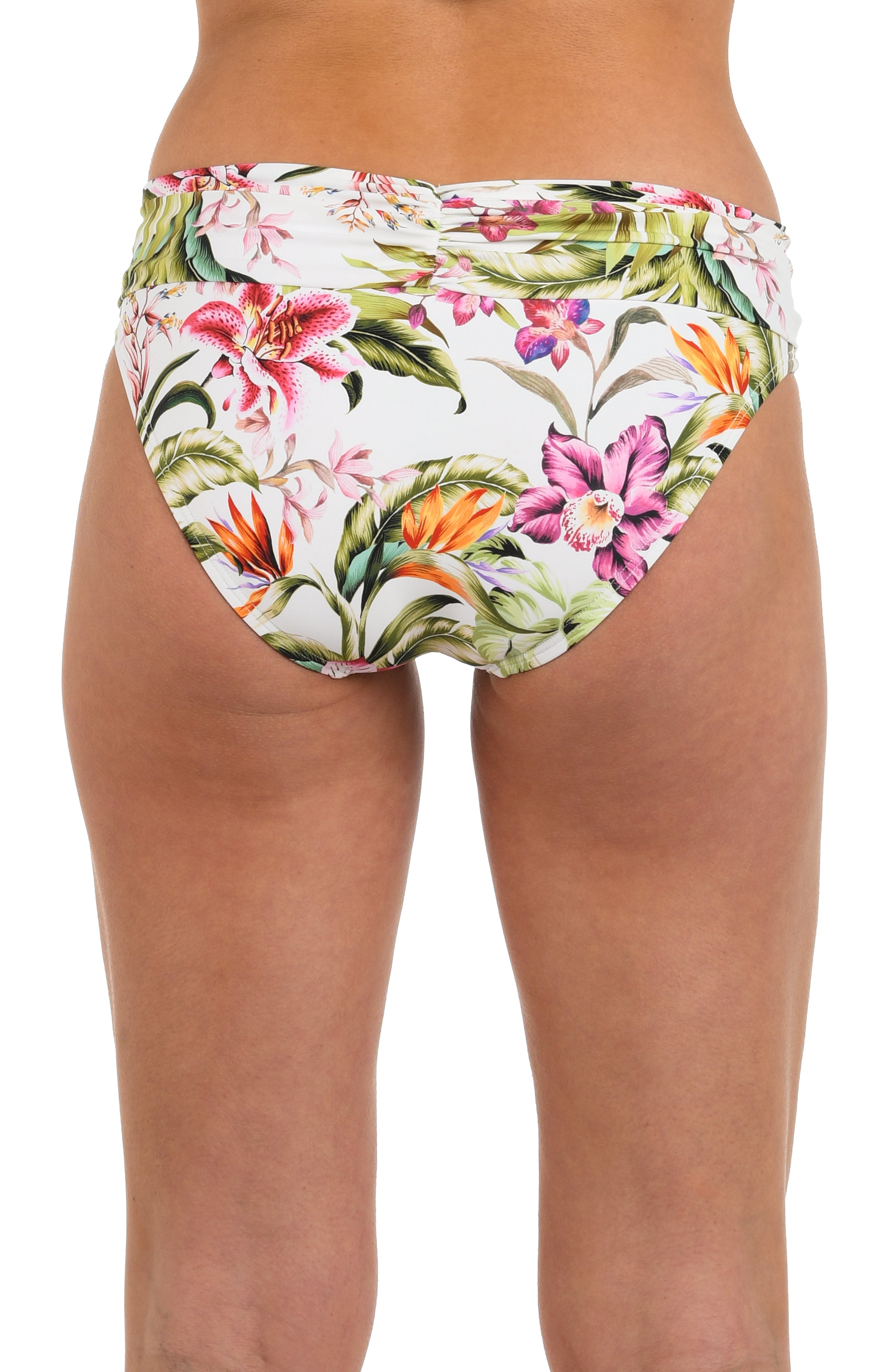 Back image of model wearing a white, pink, and green multicolored floral printed hipster bikini bottom featuring a shirred band and moderate rear coverage.