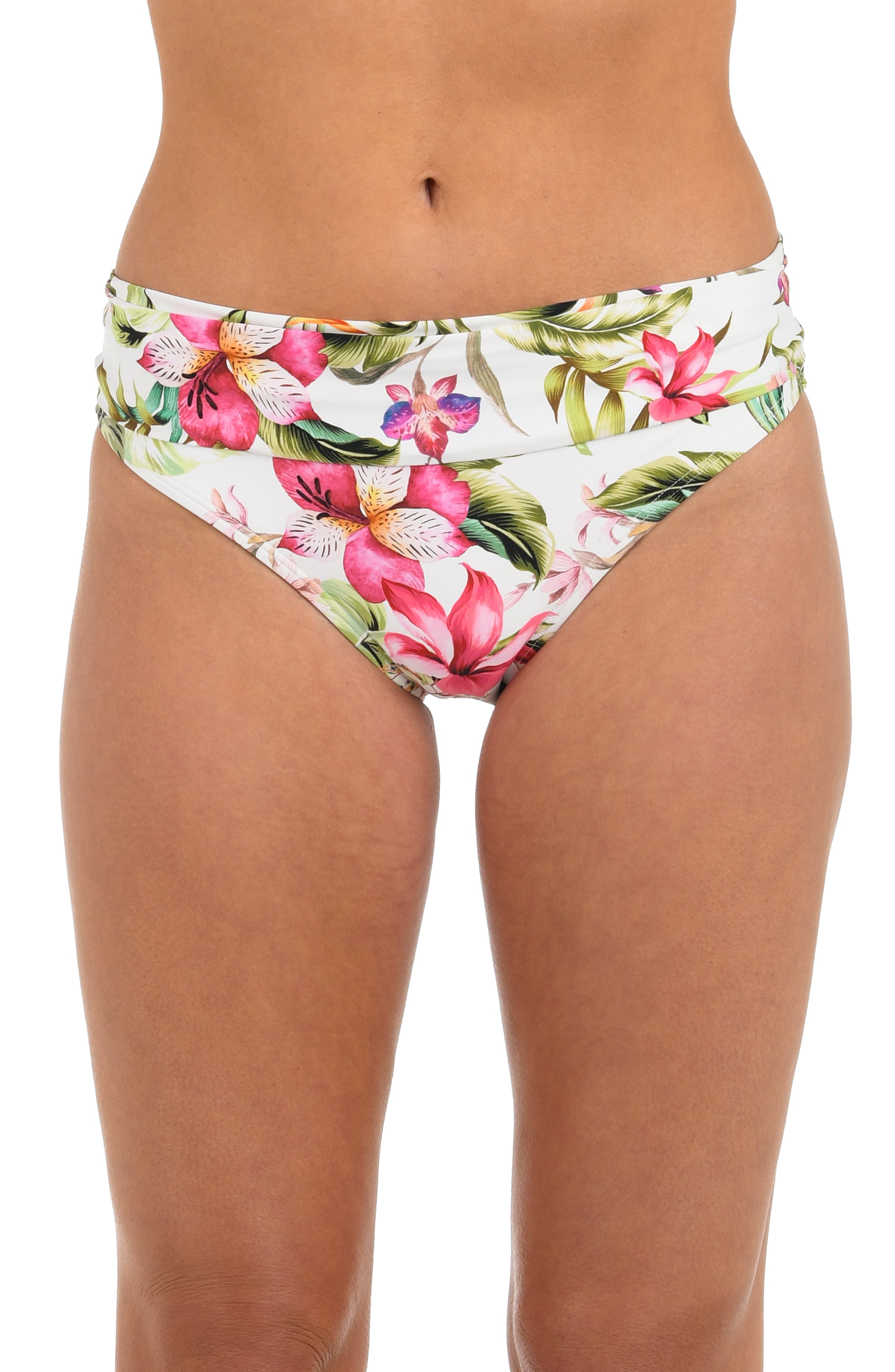Front image of model wearing a white, pink, and green multicolored floral printed hipster bikini bottom featuring fold-over shirred banding. 