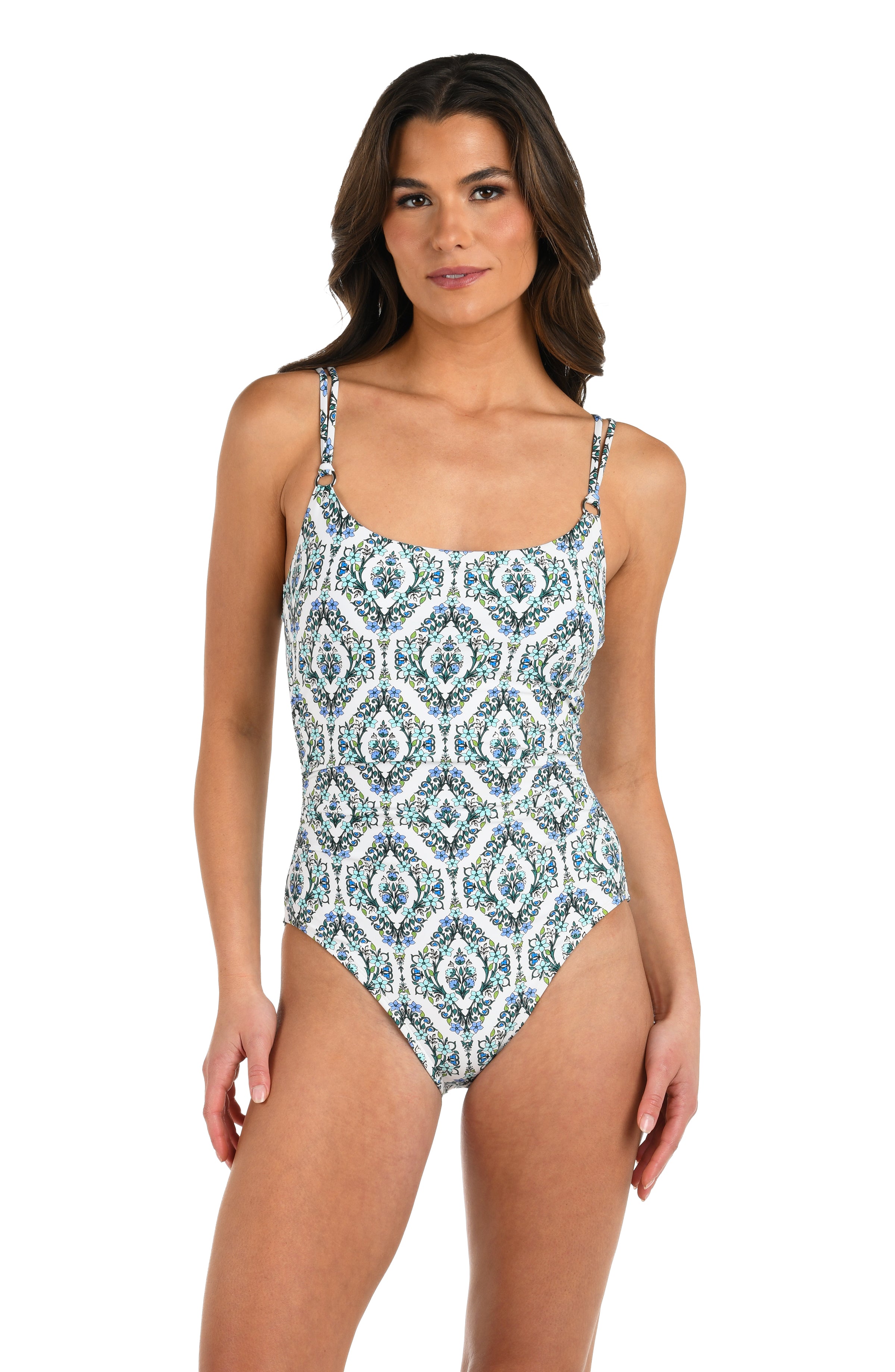 Front image of model wearing a one-piece swimsuit with a blue and green tile-inspired print, featuring thin over the shoulder straps. 