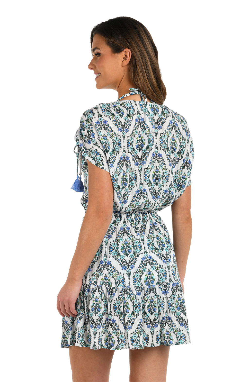 Side image of model wearing a blue and white geometric patterned V-neck short cover up dress. 
