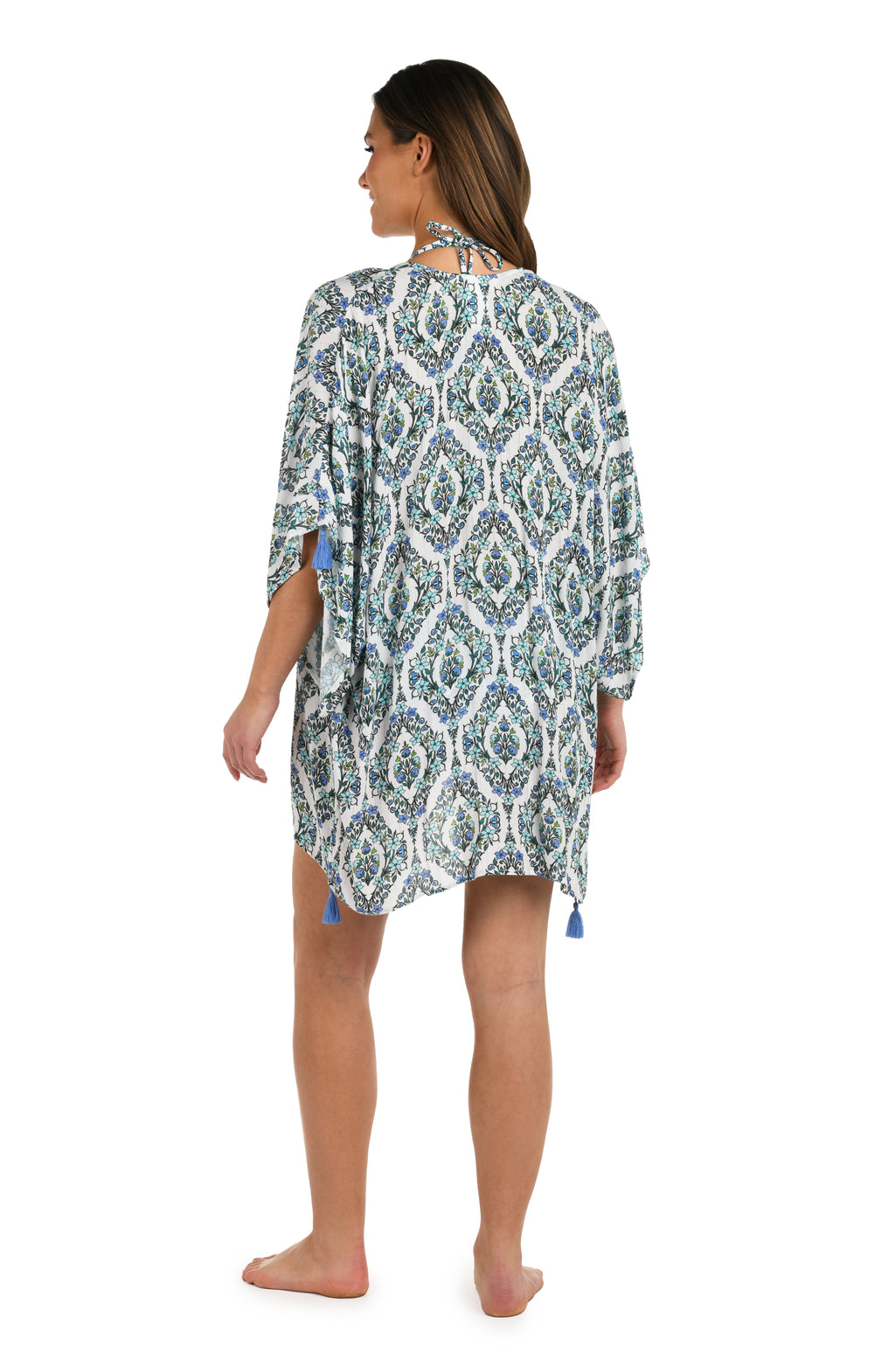 Full body back image of model wearing a blue and white geometric patterned open front kimono cover up. 