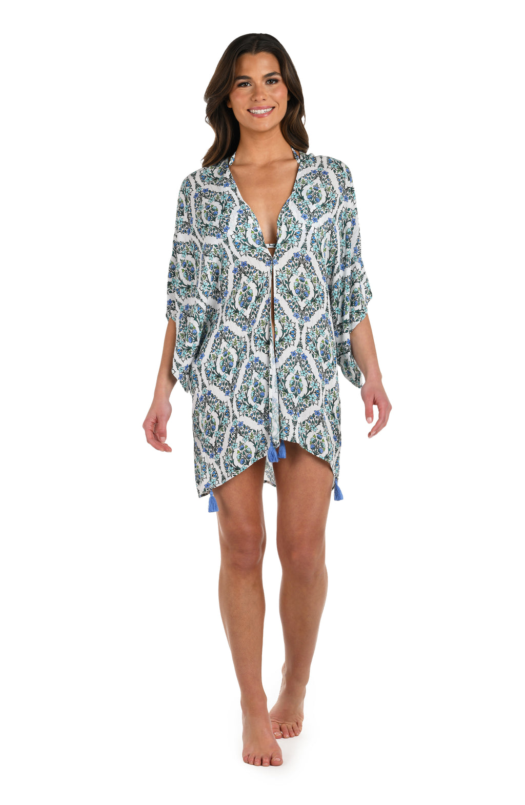 Full body front image of model wearing a blue and white geometric patterned kimono cover up. 
