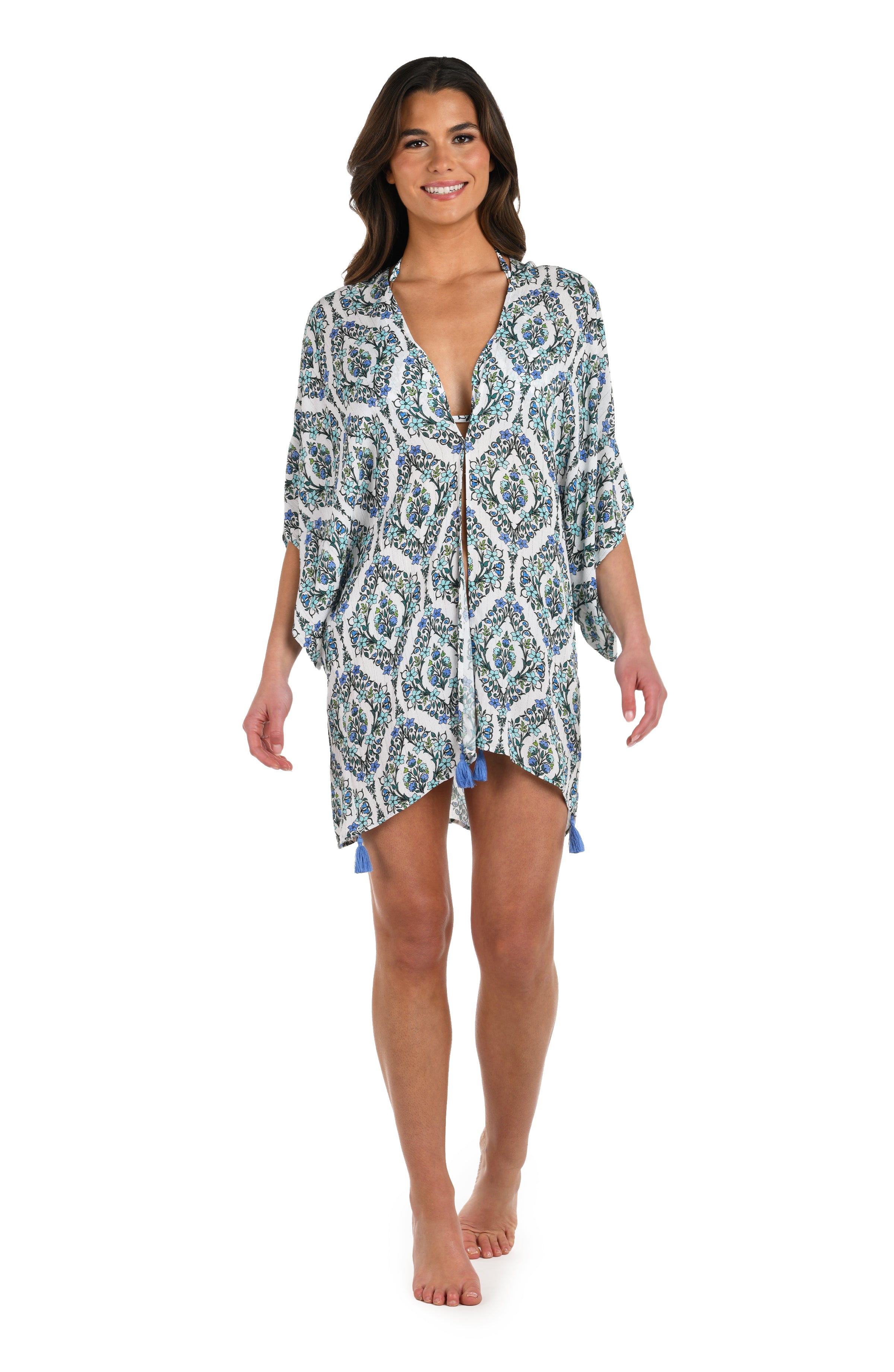 Full body front image of model wearing a blue and white geometric patterned kimono cover up. 