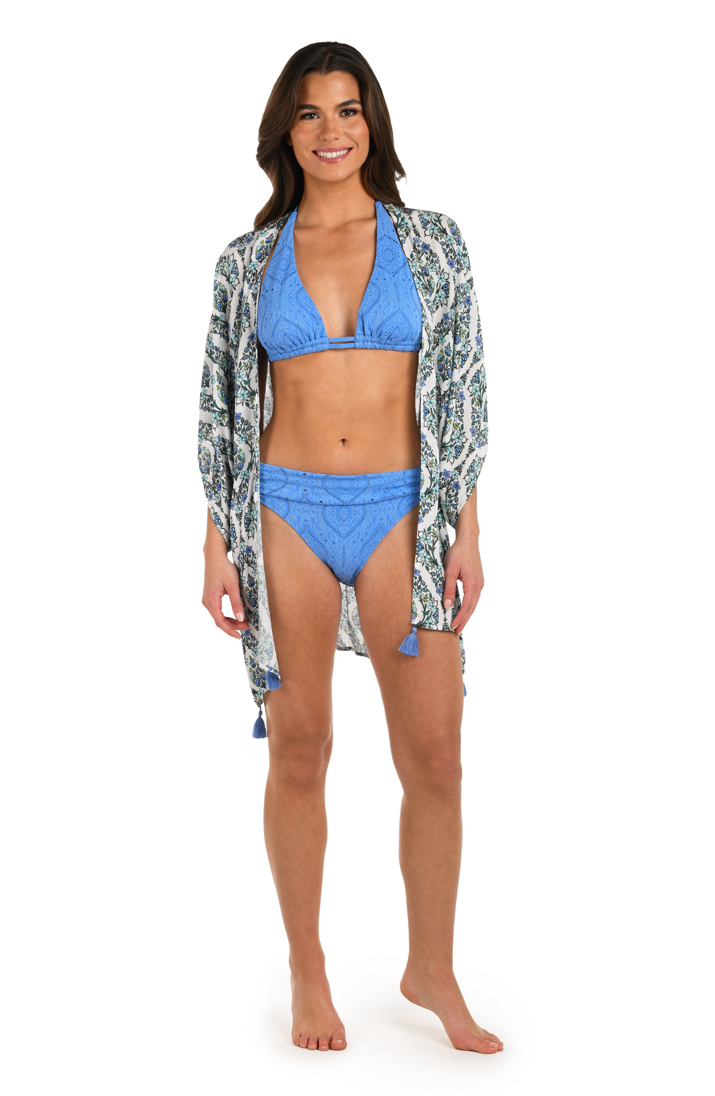 Full body front image of model wearing a blue and white geometric patterned open front kimono cover up. with a Chambray colored bikini underneath. 
