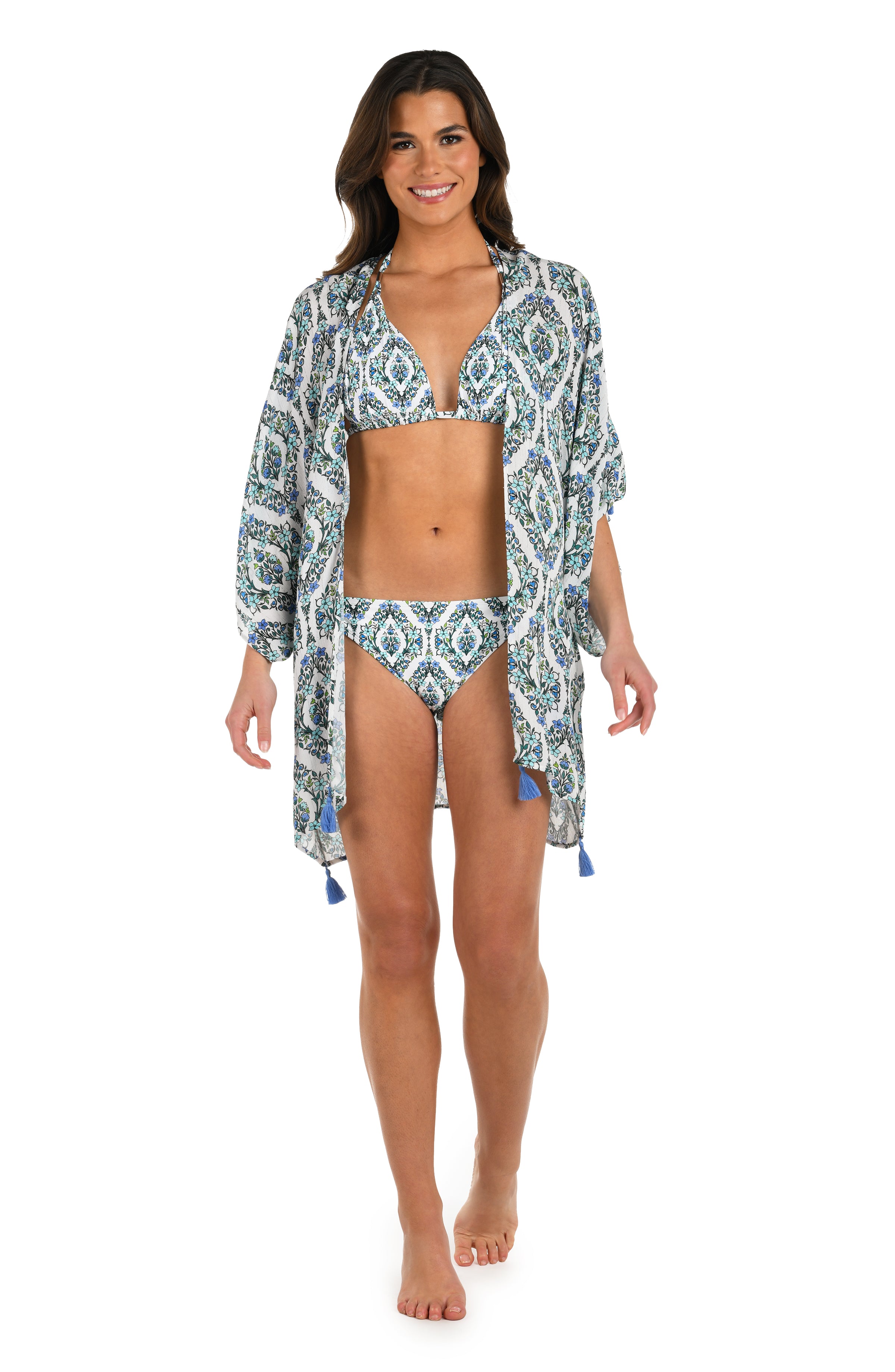 Full body front image of model wearing a blue and white geometric patterned open front kimono cover up with a matching bikini underneath. 