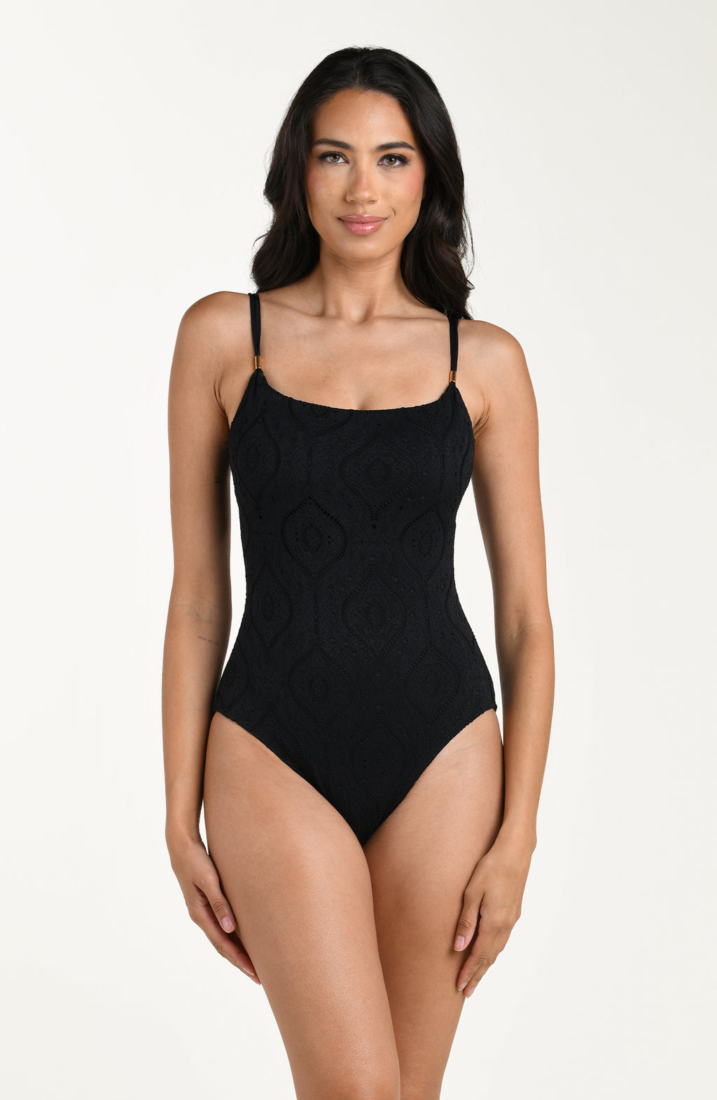 Front image of model wearing a black colored jacquard fabric one piece swimsuit featuring thin over the shoulder straps. 