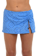 Front image of model wearing a chambray colored jacquard fabric swim skirt featuring side detailing, and an adjustable drawstring.