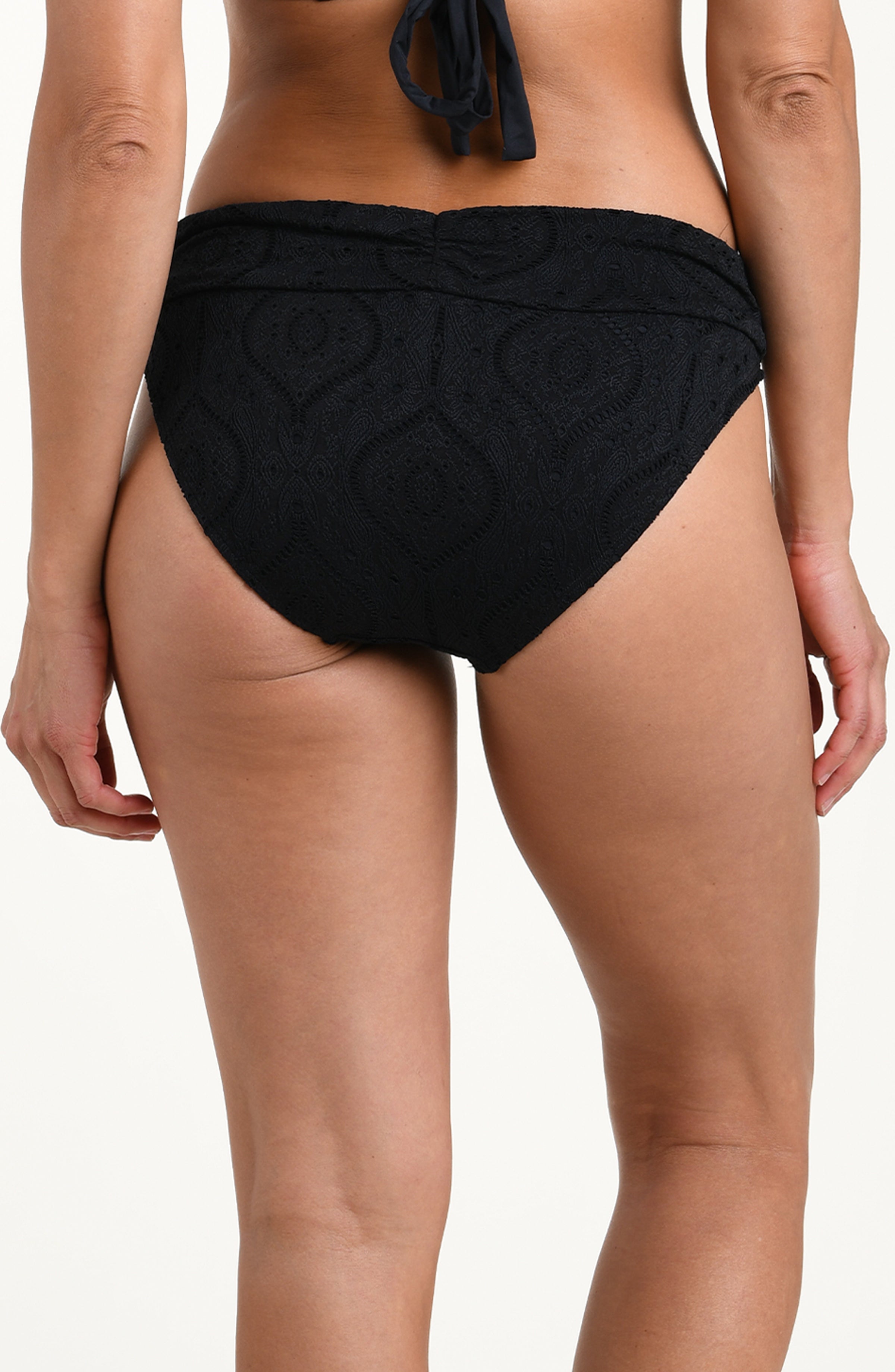 Back image of model wearing a black colored jacquard fabric hipster swimsuit bottom featuring a shirred band and moderate rear coverage.