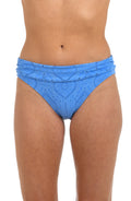 Front image of model wearing a chambray colored jacquard fabric hipster swimsuit bottom featuring a shirred front band. 